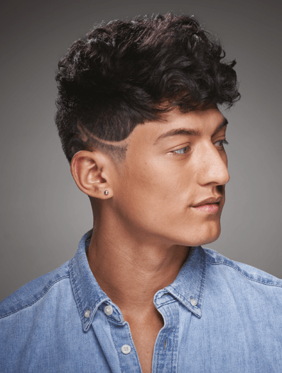 Man with a fade haircut dressed in denim shirt looking to the right