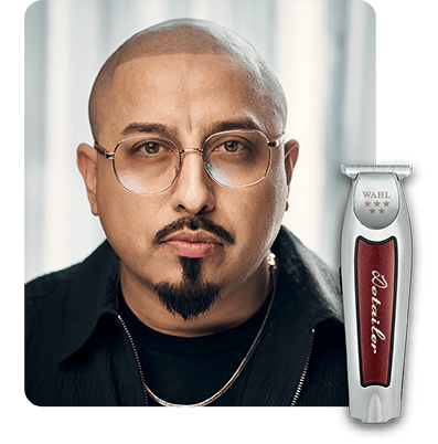 Barber with glasses portrait pictured with a Wahl Detailer Li trimmer